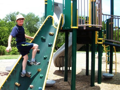 Ken Climbing on a Playground Structure